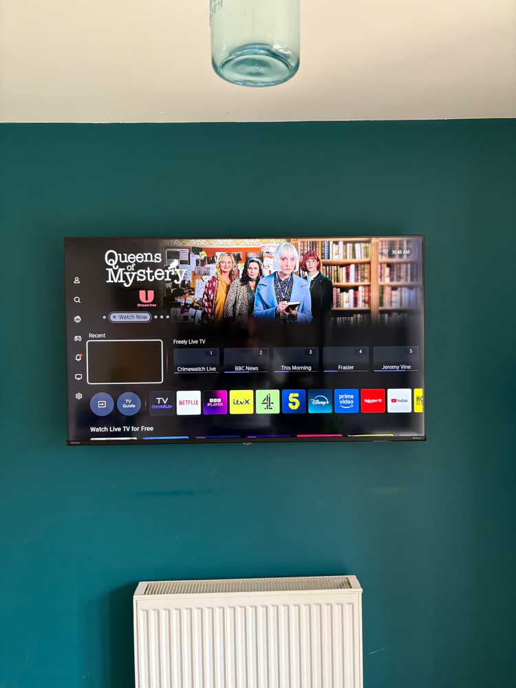 Finished wall-mounted TV installation with power cable hidden from view