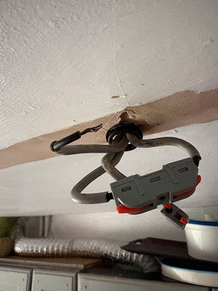 Existing ceiling wiring inspected during electrical fault finding