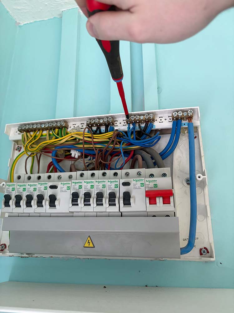 JTI Electrical consumer unit with exposed fixed wiring during electrical work