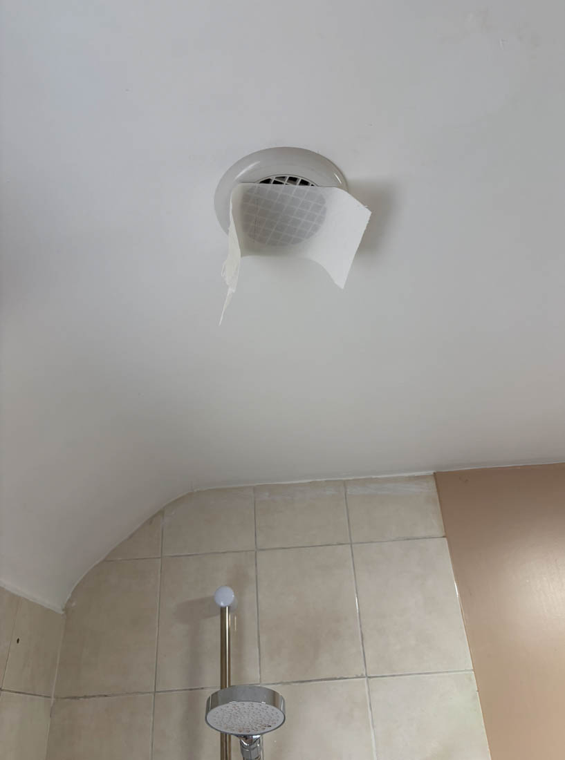 Tissue paper drawn towards a working bathroom extractor fan